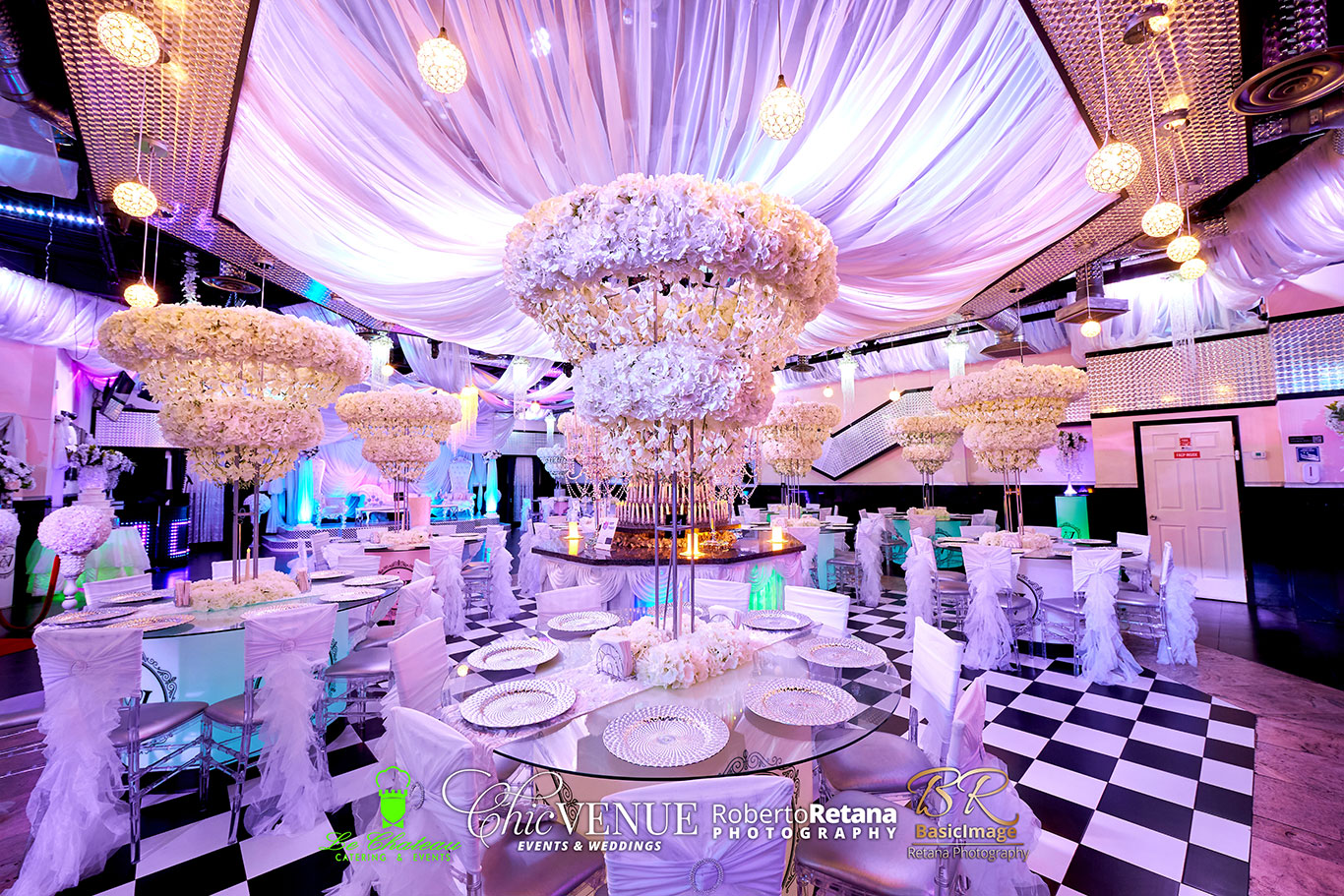 Celebration tables and stage configured for a graduation party