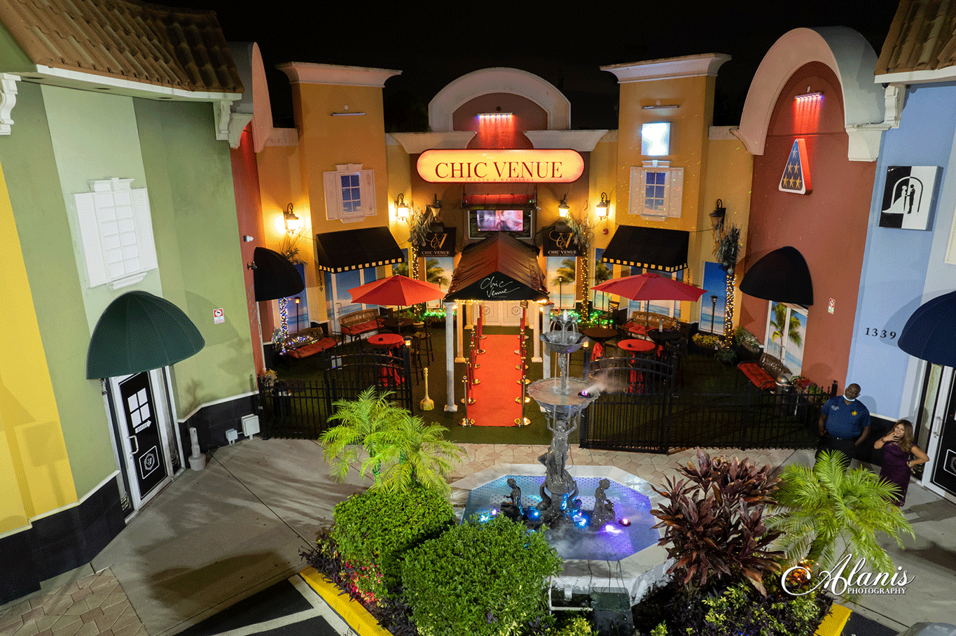 Colorfully illuminated courtyard entrance at Chic Venue